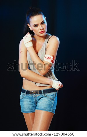 camo girl female fighter looking  aggressive over dark background