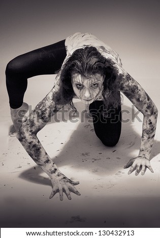 scary woman covered in mud monochrome image