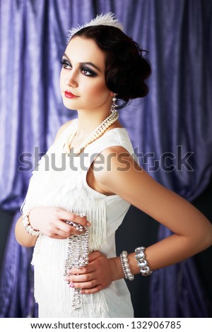 Beautiful young woman close up portrait in retro flapper style headband bw Vogue style vintage