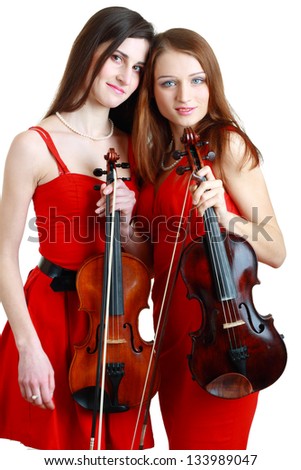 two beautiful young violinist woman isolated over white