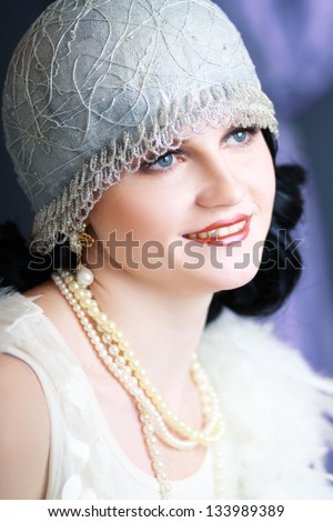Beautiful young woman close up portrait in retro flapper style headband Vogue style vintage