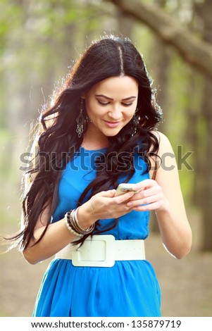 A shot of an Asian student girl texting on the phone