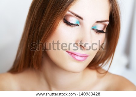 make-up woman close up face with bright make up looking down