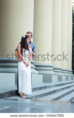 couple outdoor walking on stairs of old building