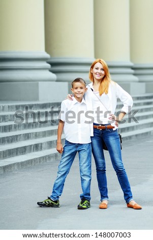 Young woman and at her son near school