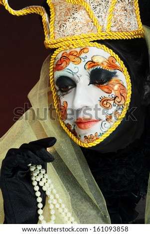 Beautiful woman with Venetian mask make up white and gold color with gold border and crown