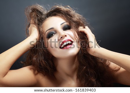happy smiling playful woman touching her head and hair joyful satisfied