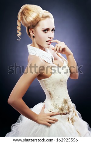Portrait of young woman with perfect make-up and cute hair style like a doll