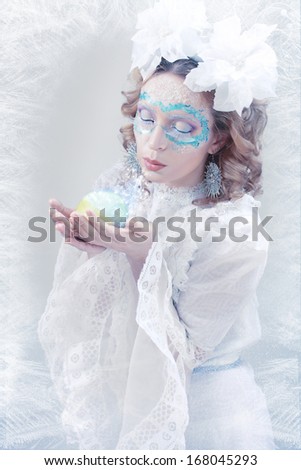 ice-queen. Winter woman in creative image with silver blue artistic make-up and perfect hairstyle.