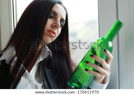 Alone young woman in depression drink alcohol