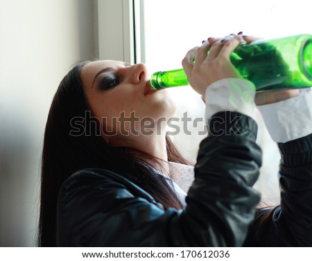 Alone young woman in depression drink alcohol