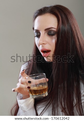 Young crying woman in depression drink drinking alcohol Dark tone image