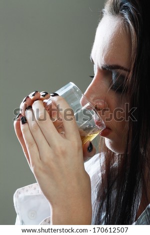 Young crying woman in depression drink drinking alcohol Dark tone image