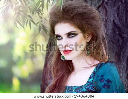 Young woman outdoors fashion portrait style Boho in the forest. Fashion color tint