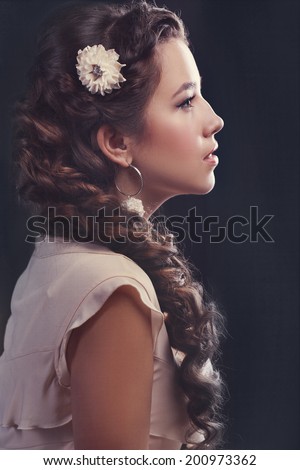 Candid Portrait Beautiful Young Woman Portrait. Long Brown Hair. Flower in hairs. Fashion toning