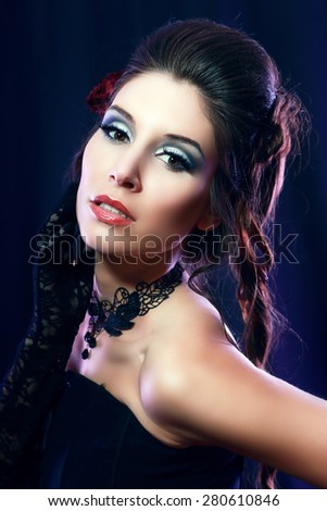 beautiful fashion vampire victorian style woman posing over dark background