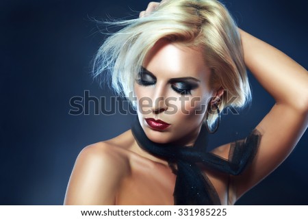 portrait of a beautiful blond girl with short hair and bright make-up