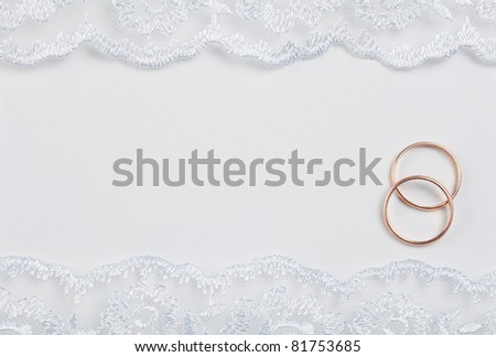 stock photo wedding invitation decorated with lace with rings over it