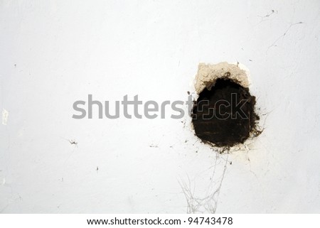 black hole in in white wall as a background