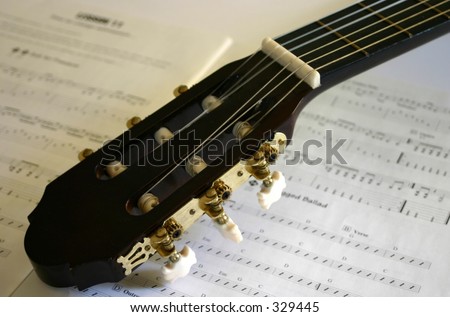 acoustic guitar head with sheet of music
