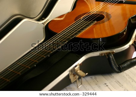 acoustic guitar in hard case with sheet music