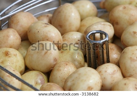 Close of up washed potatoes in their jackets in a steamer
