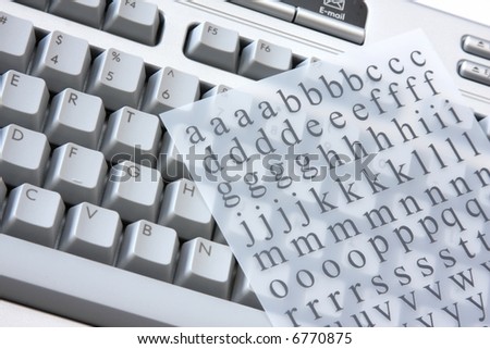 Close up of keyboard on computer against white background with letter sheet