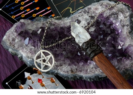 wiccan tools and jewelry against amethyst crystal and tarot cards