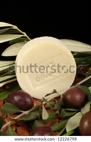 natural olive oil soap olives branch against wooden mat