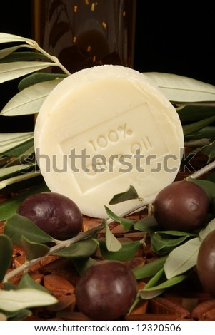 natural olive oil soap olives branch against wooden mat