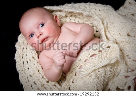 healthy young baby in woolen shawl