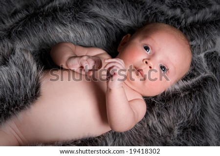 young healthy baby on fur rug