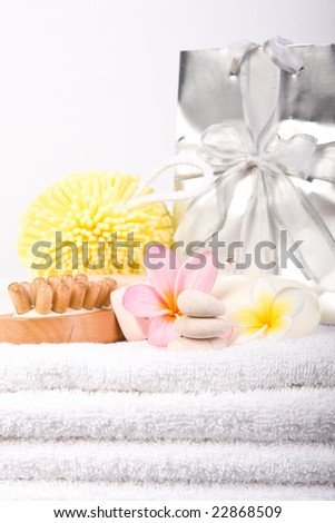 day spa beauty pamper products on white towel with gift bag