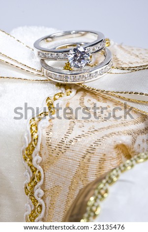close of up engagement and wedding rings on gift box