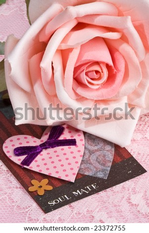 'soul mate' tag in front of pink rose on lace background