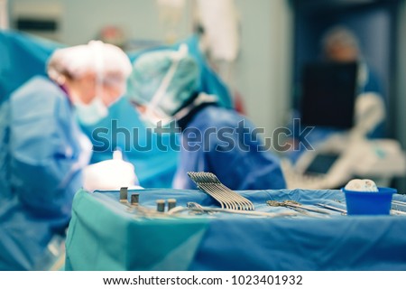 Surgical room in hospital with medical team of surgeons doing minimal invasive surgical interventions. Surgery operating room with electrocautery equipment for cardiovascular emergency surgery center