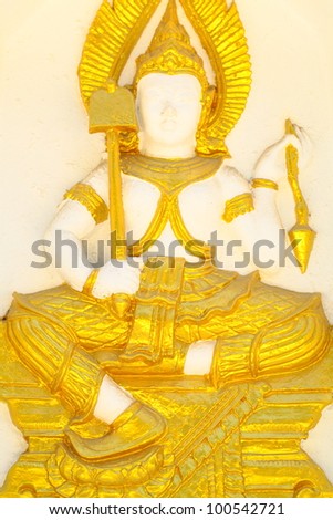 Armed goddess statue on the wall of the pagoda of Wat Thai.