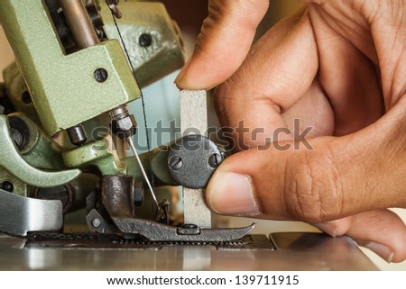 Technicians hand are customized sewing machine.