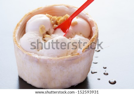 Close-up ice coconut milk in a cup of fruit.