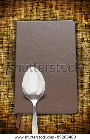 Manual.Book with a spoon on the floor.