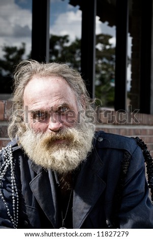 Homeless man with blue eyes and white beard.