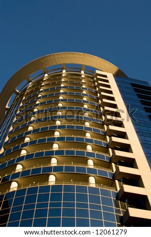 Modern High rise, A tall building against a blue sky.