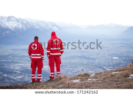 Salzburg , December 30.2013. Two Red Cross Helpers In The Austrian Mountain Are Waiting To Help A Paraglider In Need. Dezember 30, 2013 In Salzburg Gaisberg