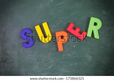 Super . Writen with colored letters on a  blackboard.