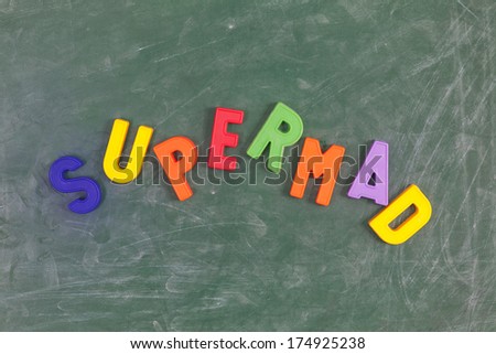 Supermad. Writen with colored letters on a  blackboard.