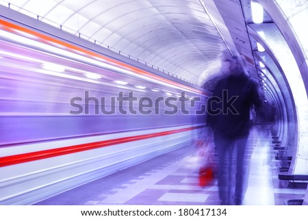 A motion picture of a subway in prague. A unsharp man is walking near the subway. picture is toned.