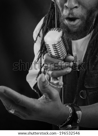 Close up picture of a Jazz Singer with a retro Mic. Picture is toned.