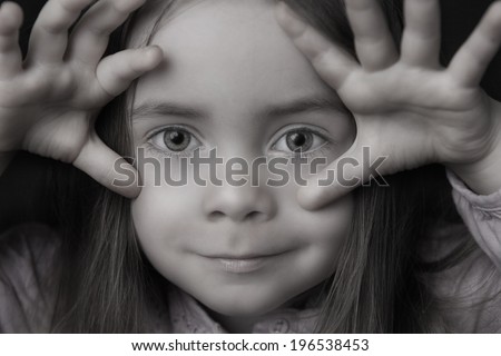 A fine art portrait of a young girl gesture with her hands.