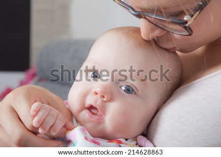 A mother hold her little daughter in her arms