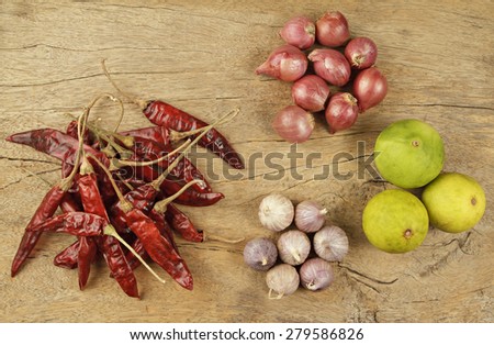 Thai food Cooking ingredients. Dried chili, shallots, garlic and lemon on wooden background.